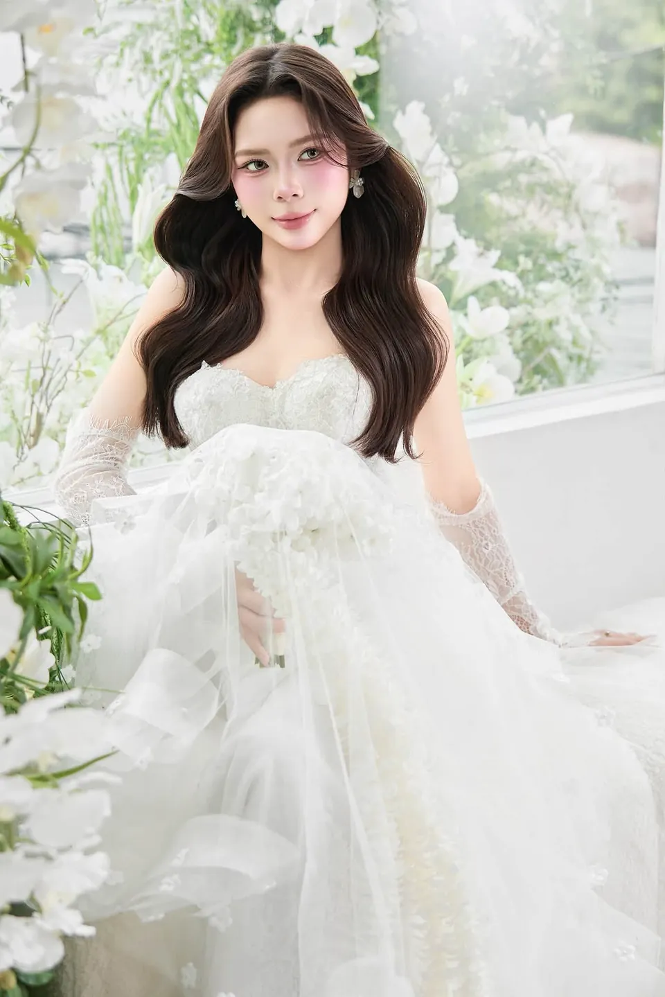 Cô dâu ngồi giữa tà váy bồng và cây xanh