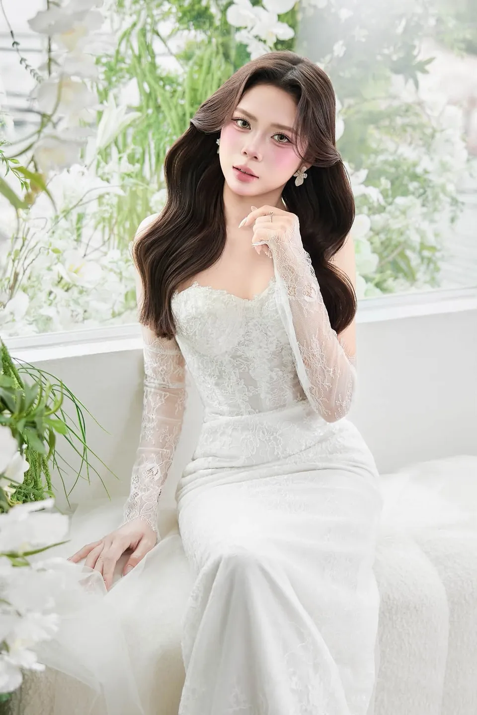 Cô dâu tóc dài uốn sóng, găng tay ren, ngồi bên cửa sổ hoa trắng